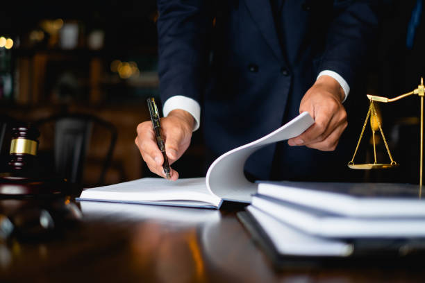 Attorney reviewing legal documents with scales of justice